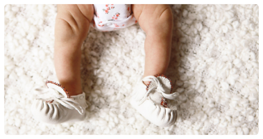 Indigenous baby, wearing traditional moccasins