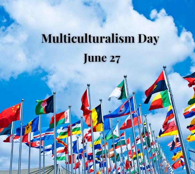 A blue sky with a series of flags from different countries pictured flying high. The words “Multiculturalism Day” are printed in the centre of the design.  