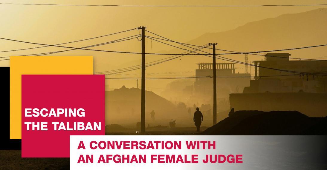 Poster of a foggy scene representing an Afghanistan city with a lone person walking through a deserted street with two buildings and utility poles. A black, yellow, and red square are staggered on top of one another, with the words “Escaping the Taliban” inside. The description, “A conversation with an Afghan female judge.”