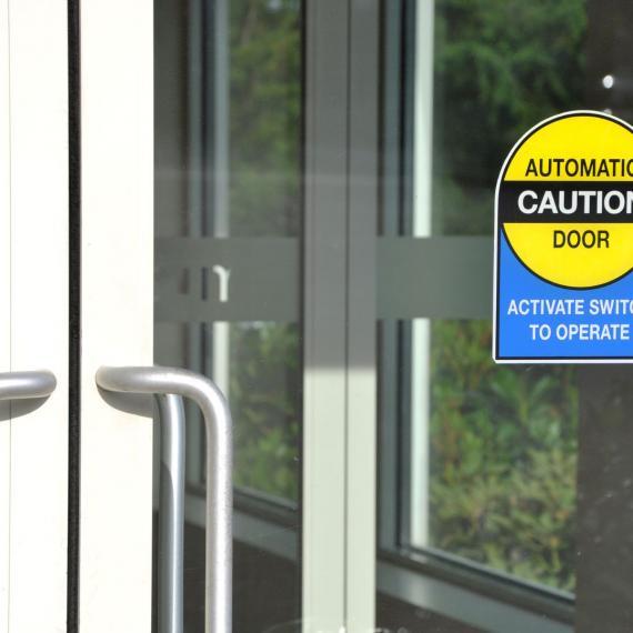 Picture of a closed automatic door with handles.