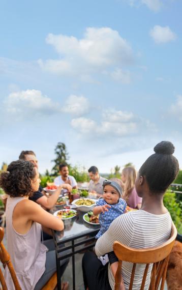 Diverse family gathering around an outdoor table