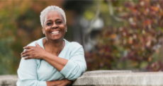 An elderly women smiling at the camera