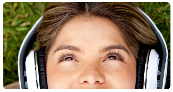 Woman with headphones on, listening to the radio